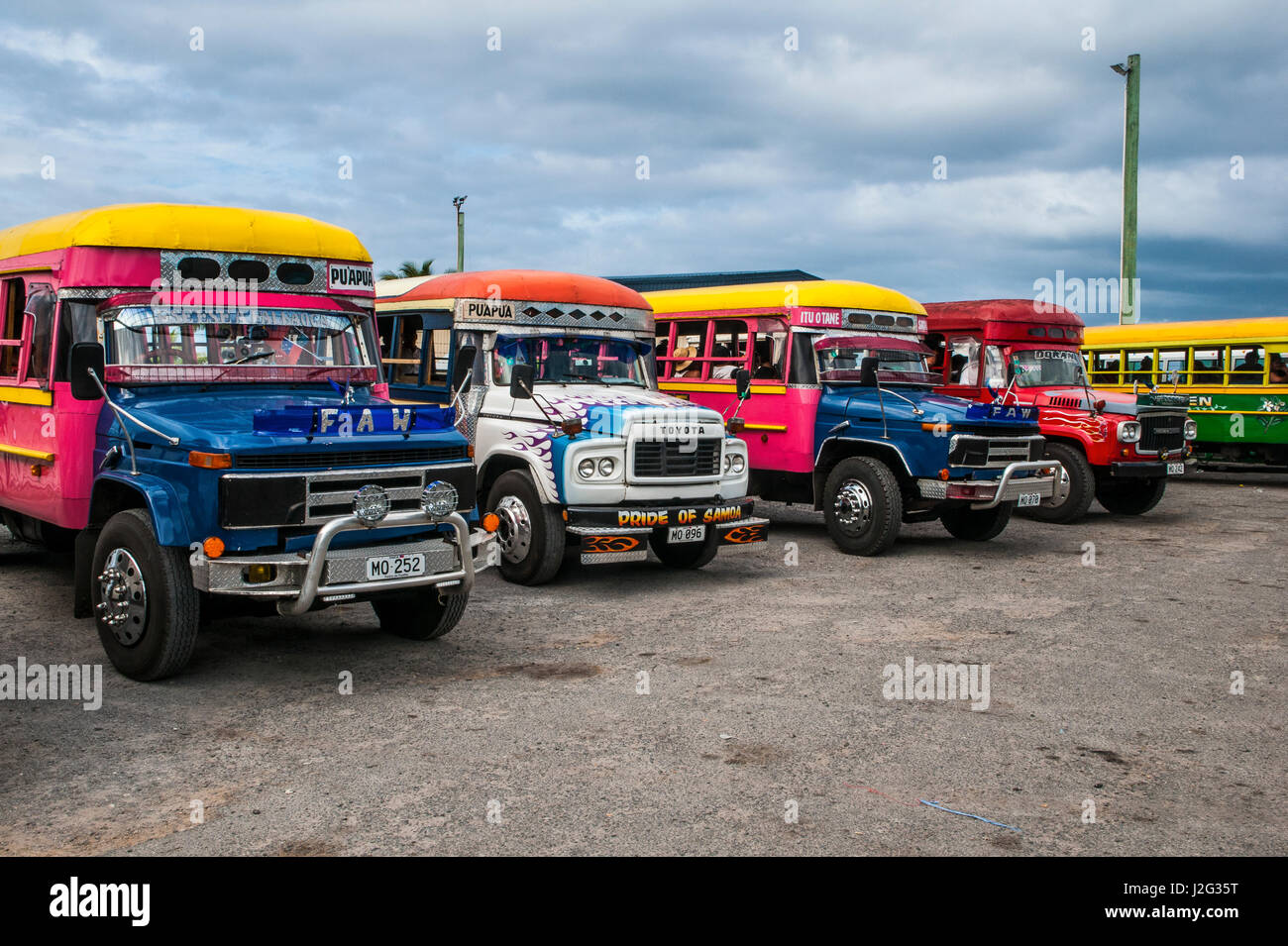 Local bus fleet waiting for the ferry in Savai'i, Samoa, South Pacific ...