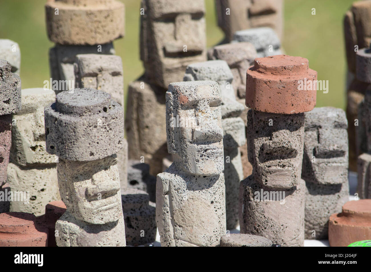 Chile, Easter Island aka Rapa Nui. Typical souvenir handicrafts for sale around the island. Carved volcanic stone moi figures. Stock Photo