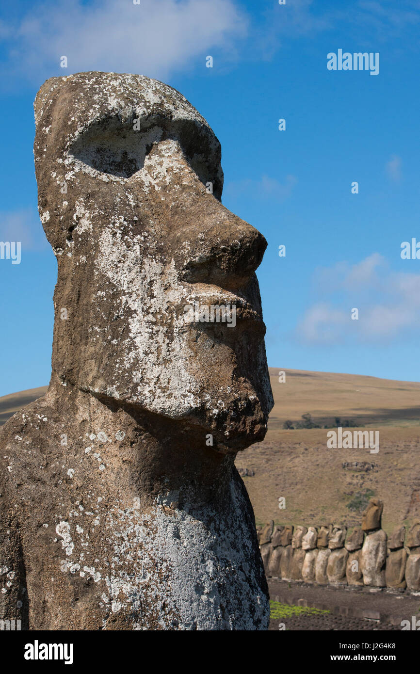 Chile, Easter Island, Hanga Nui. Rapa Nui National Park, Ahu Tongariki (aka Tonariki). 'Traveler' moi at park entry, largest ceremonial platform in all of Polynesia in the distance. Stock Photo