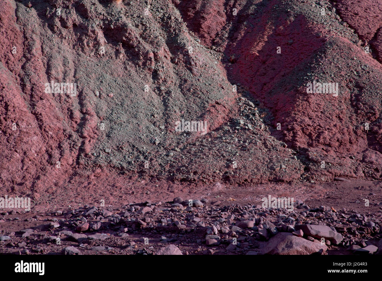 A close-up look at the mineral rich rock formations of Rainbow Valley, found in the Domeyko mountains of the Atacama desert in Chile. Stock Photo