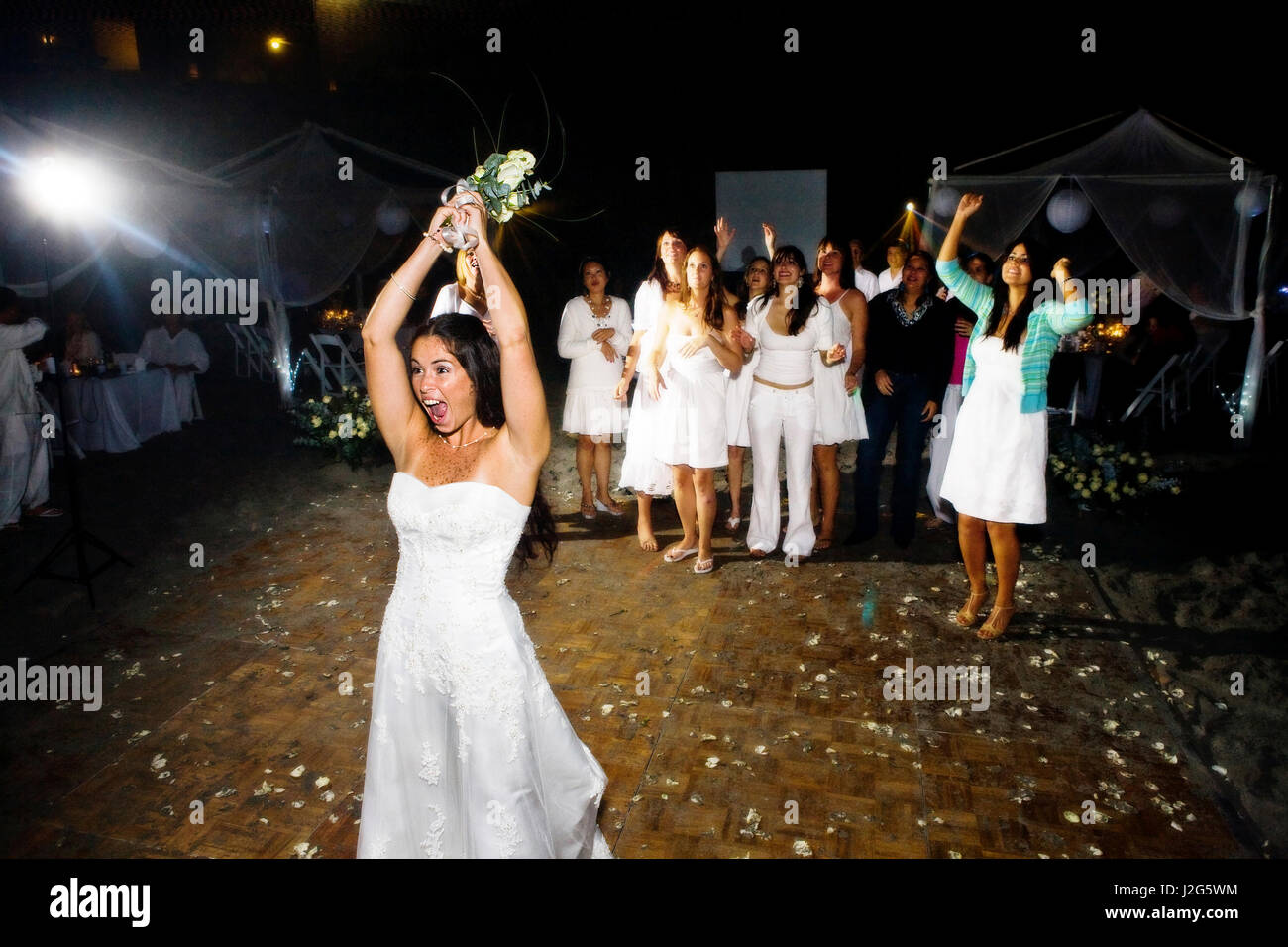 A bride throws her flowers into the crowd Stock Photo Alamy