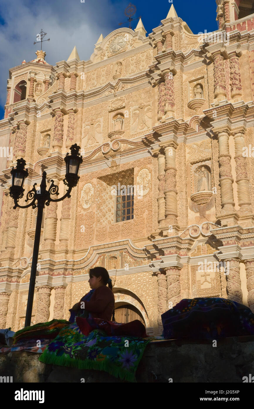 Market trader in front of Santo Domingo Church founded in 1528 with famous baroque facade Stock Photo