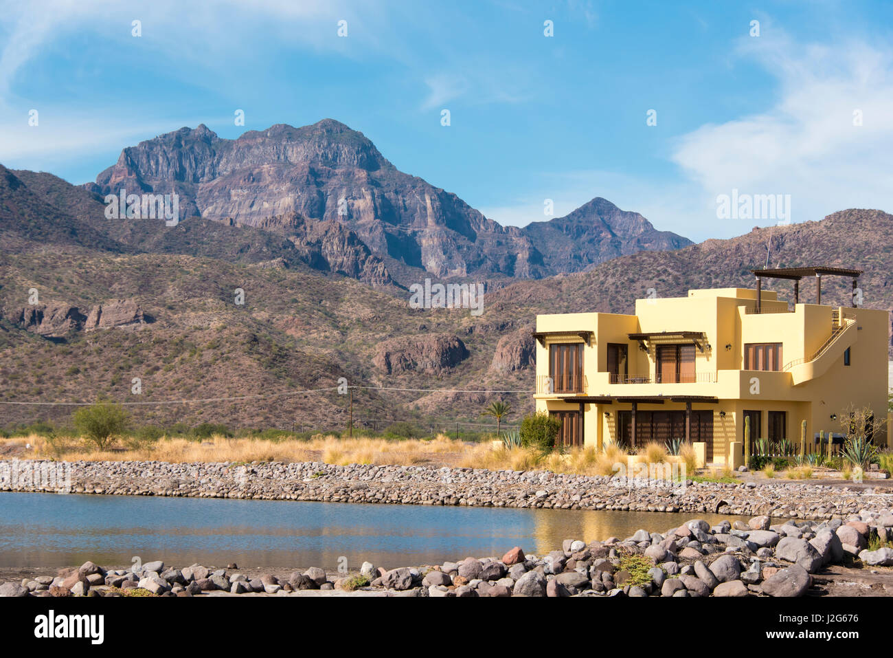 Mexico, Baja California Sur, Sea of Cortez. Loreto Bay Golf Resort and Spa.  Morning light. Waterfront homes reflected in calm water Stock Photo - Alamy
