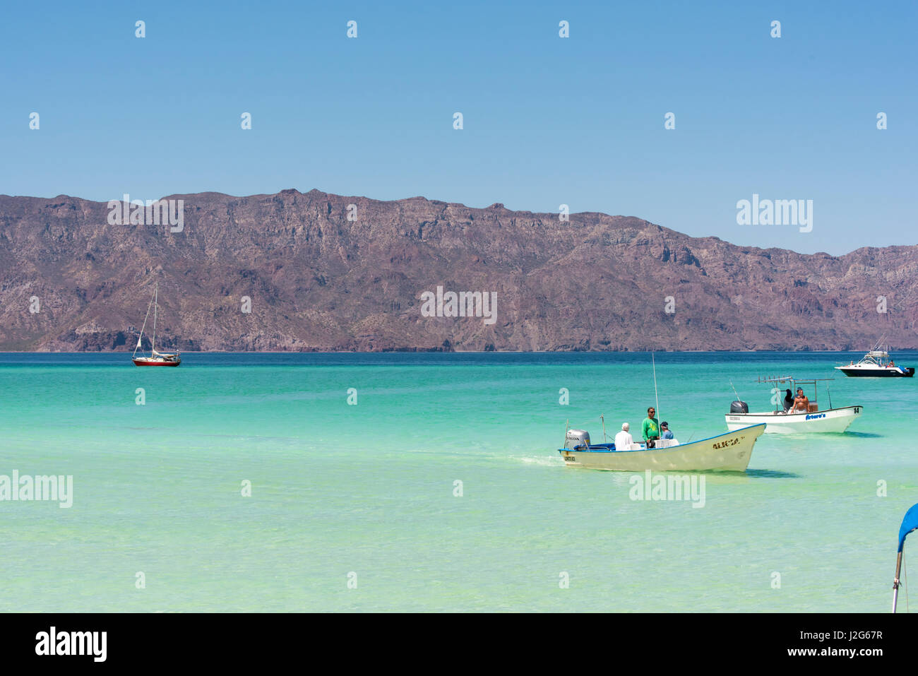 Mexico, Baja California Sur. Excursion boats approach Isla Coronado across from mainland Stock Photo