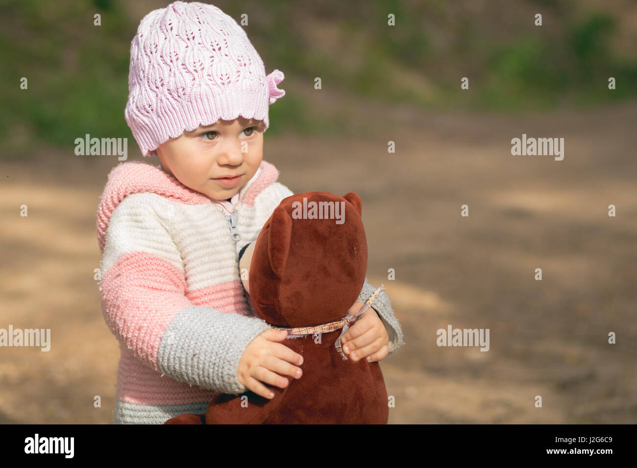 Cute little baby girl playing outdoors Stock Photo - Alamy
