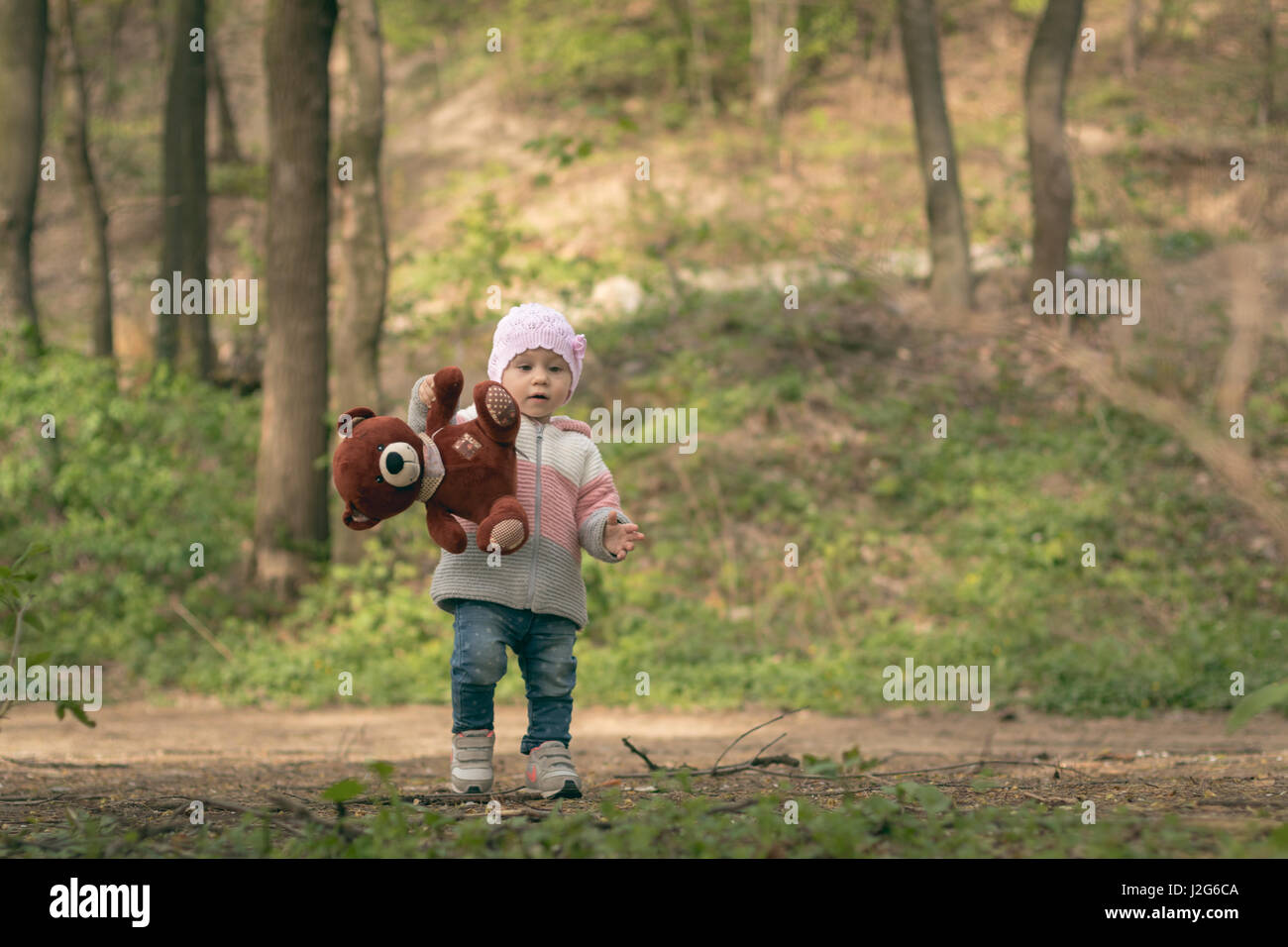 Cute little baby girl playing outdoors Stock Photo - Alamy