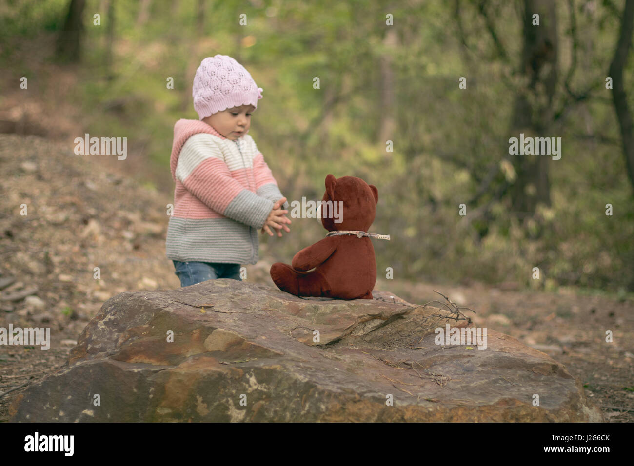 Cute little baby girl playing outdoors Stock Photo - Alamy