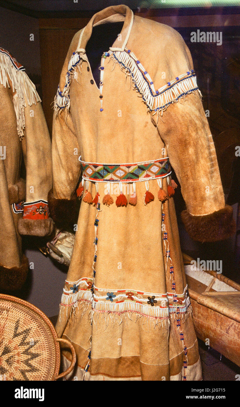 Traditional Athabaskan dress made from tanned caribou skins decorated with dentalium shells, blue trade beads beadwork and beaded belt with tassels made from colored yarn. Alaska Stock Photo