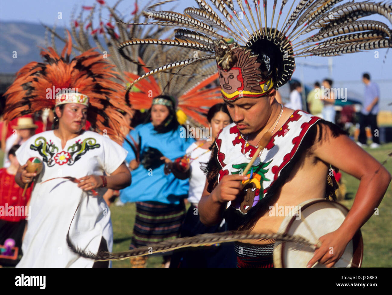 Group of Aztec dancers during a traditional march before a dance performance in Malibu Beach, California Stock Photo
