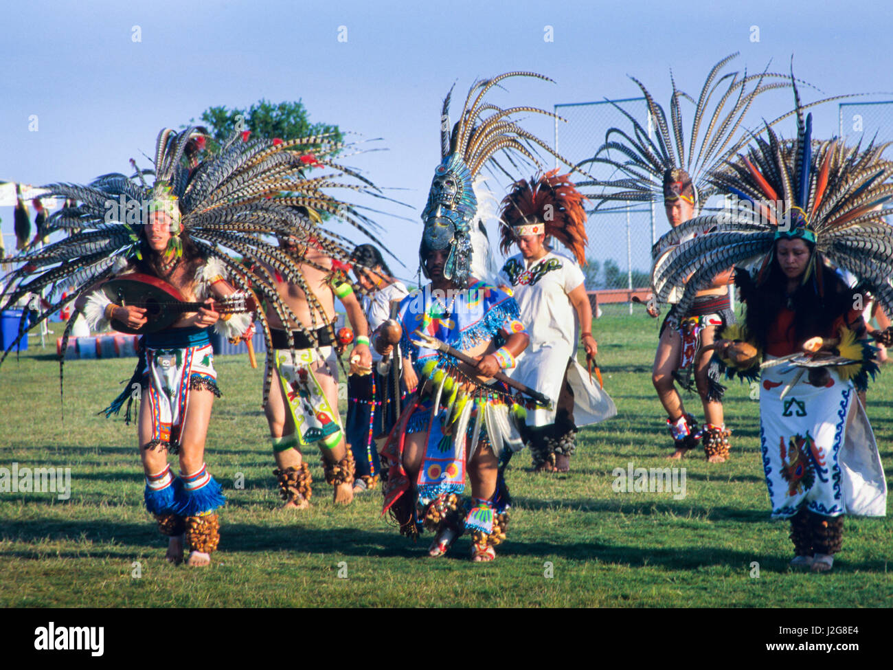 Large group of Aztec dancers display their traditions during a ceremonial presentation at a gathering in Malibu Beach California Stock Photo
