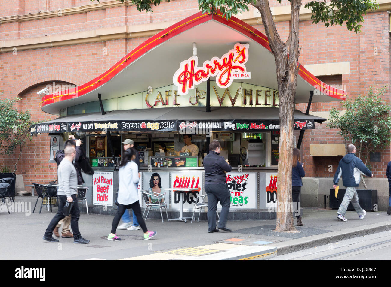 People walking past the iconic Harry's Cafe de Wheels on George street, Sydney, Australia Stock Photo