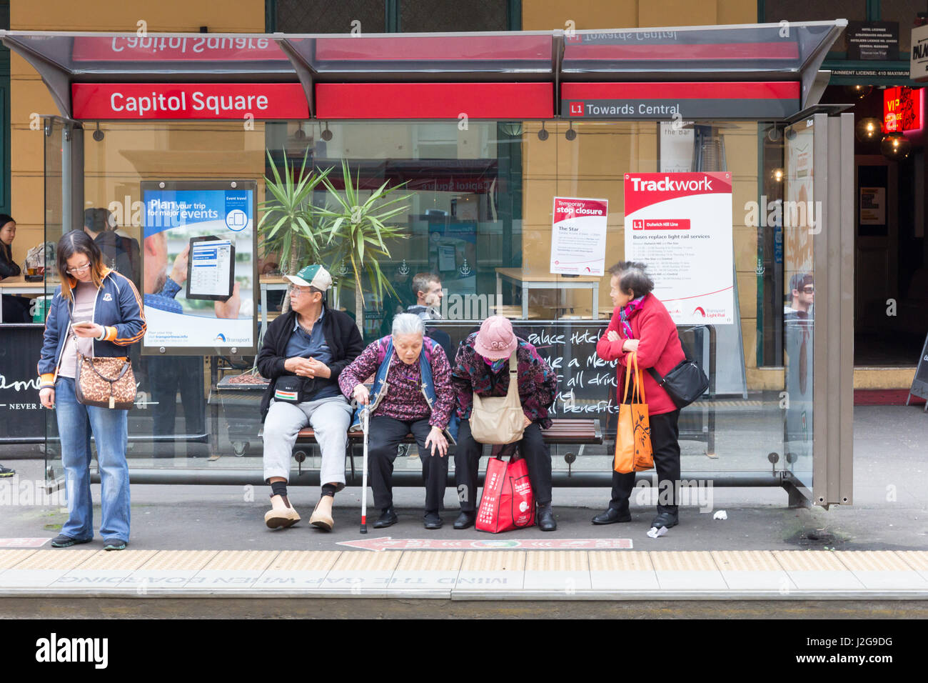 Passengers waiting for the tram at the Capitol Square stop in Chinatown, Sydney, Australia Stock Photo