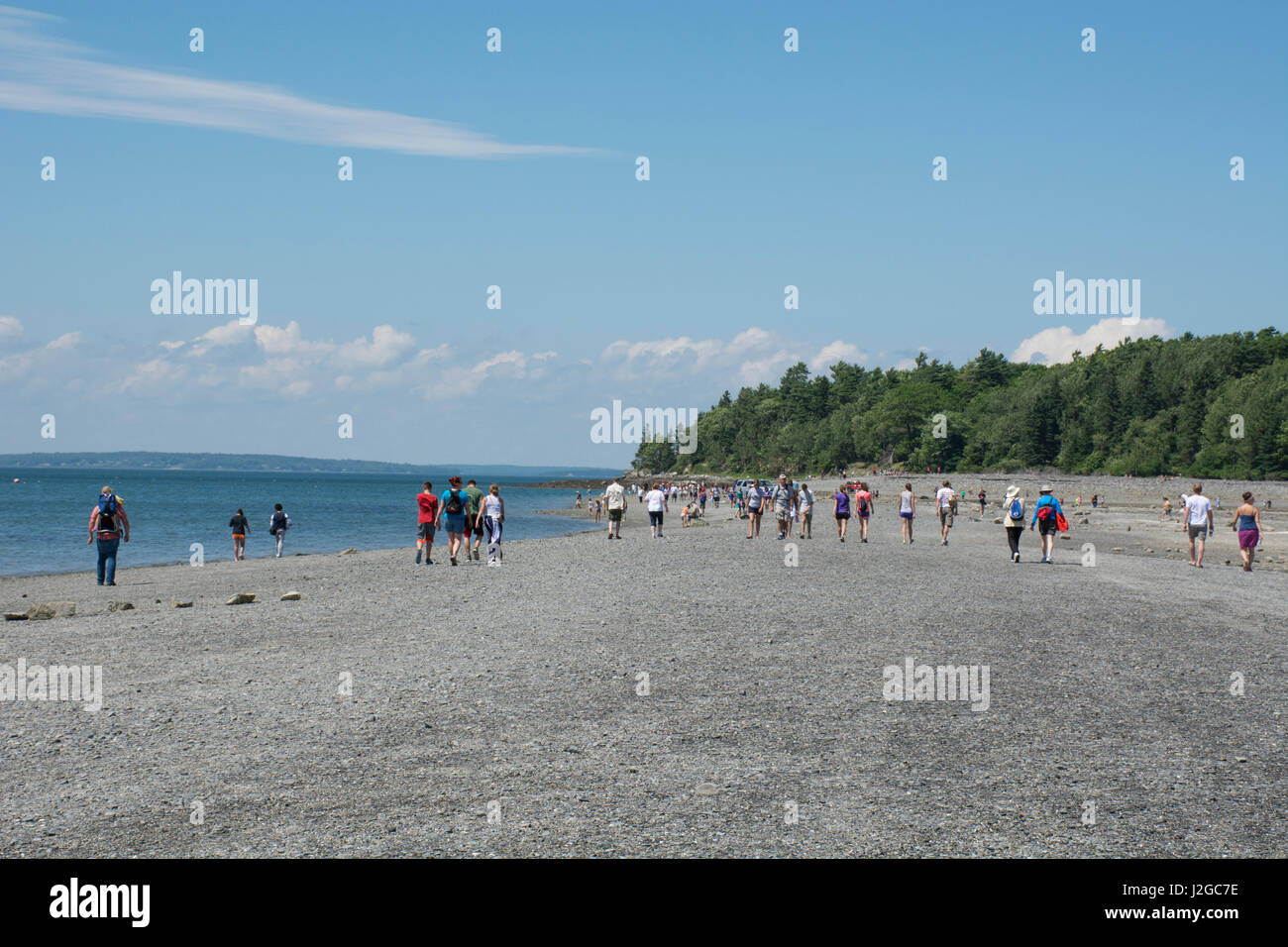 Maine, Bar Harbor. Bar Island, accessed only at low tide by a natural land bridge that emerges from the ocean. Tourists crossing over the Land Bridge at low tide. Stock Photo