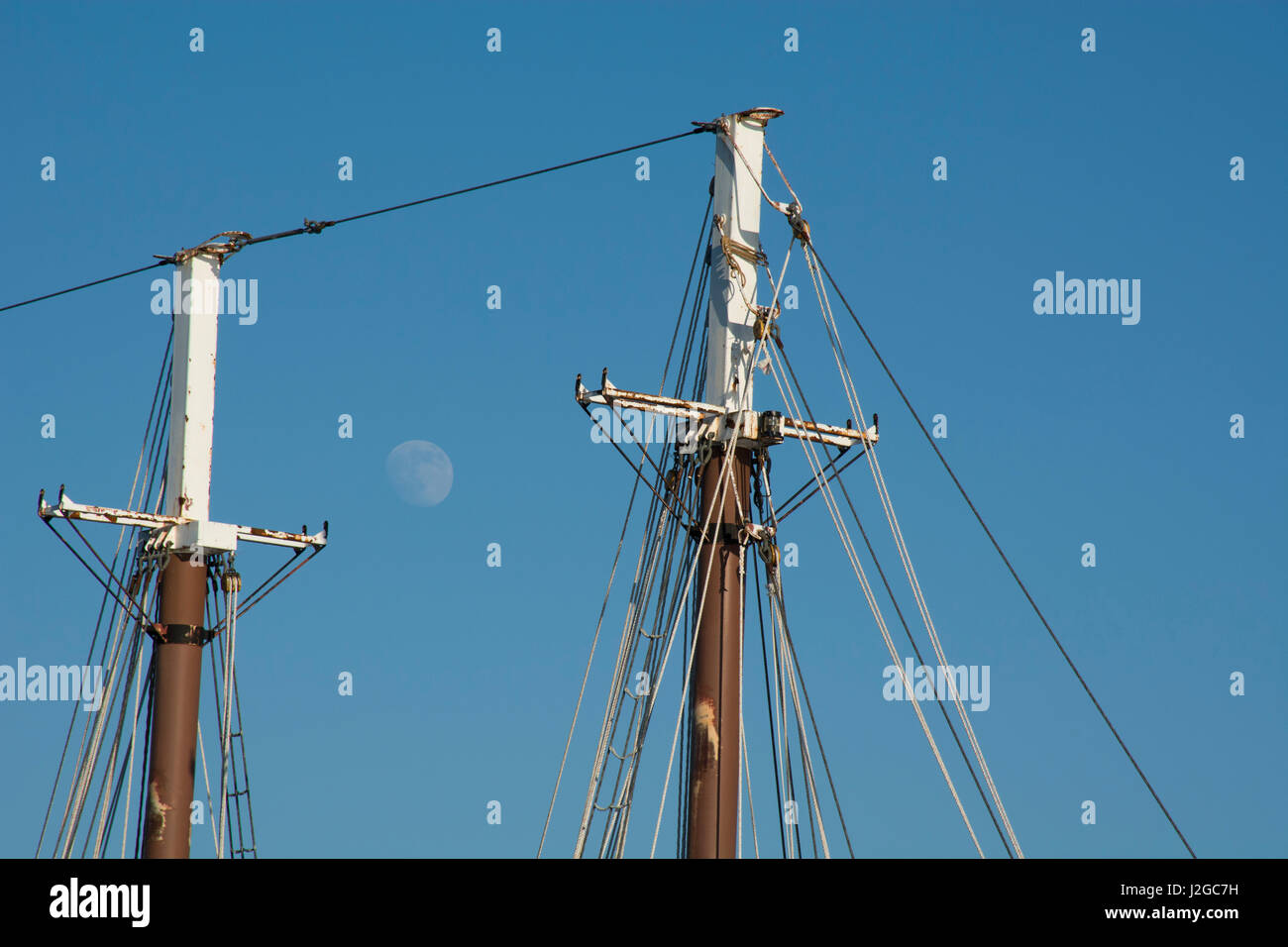 Maine, Bar Harbor. Tourist sightseeing boat the Margaret Todd, 151-foot four-masted schooner. Detail of masts with moon. Stock Photo