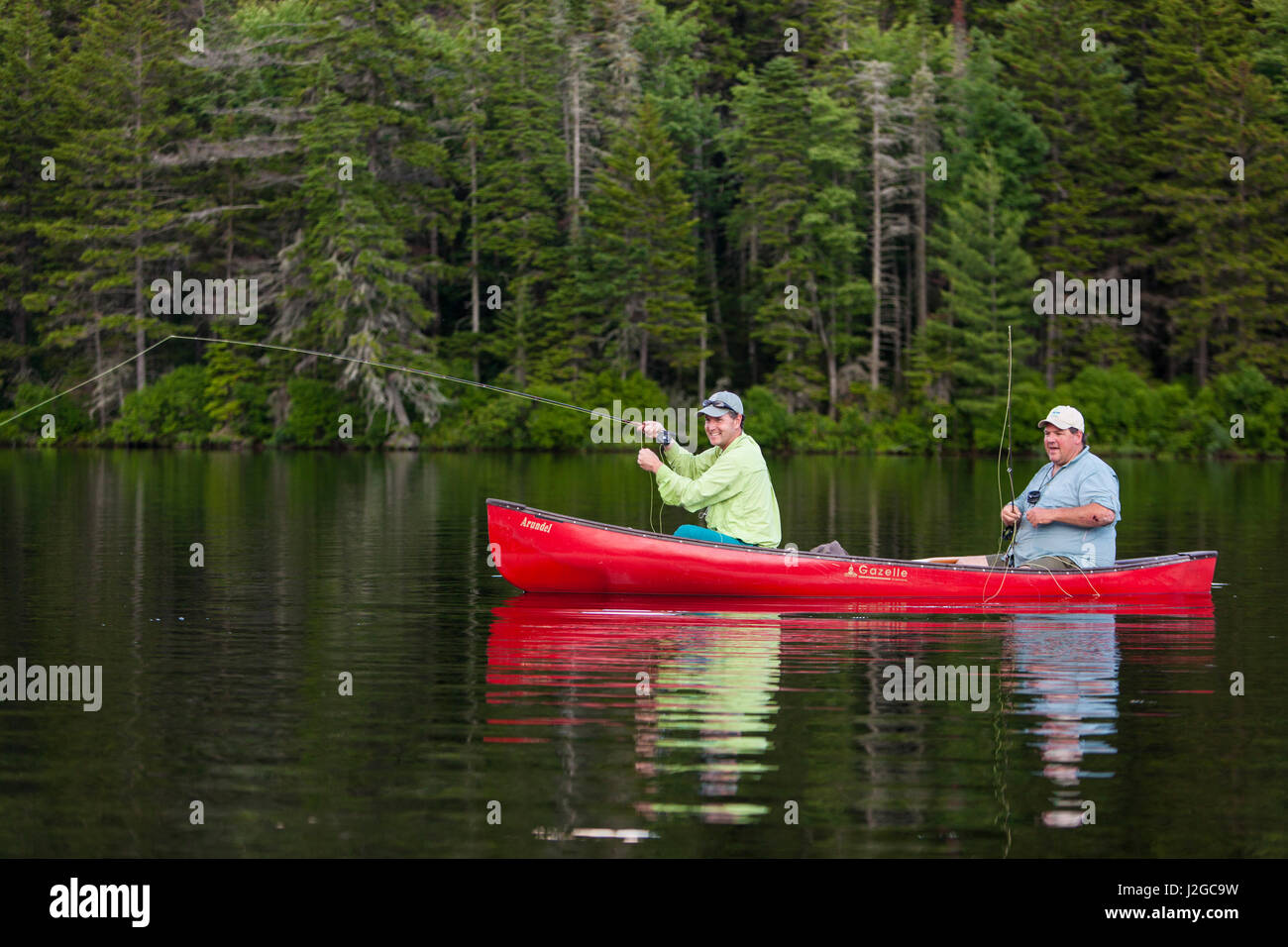 Two men flyfishing for brook trout from a canoe on Lang Pond in Maine