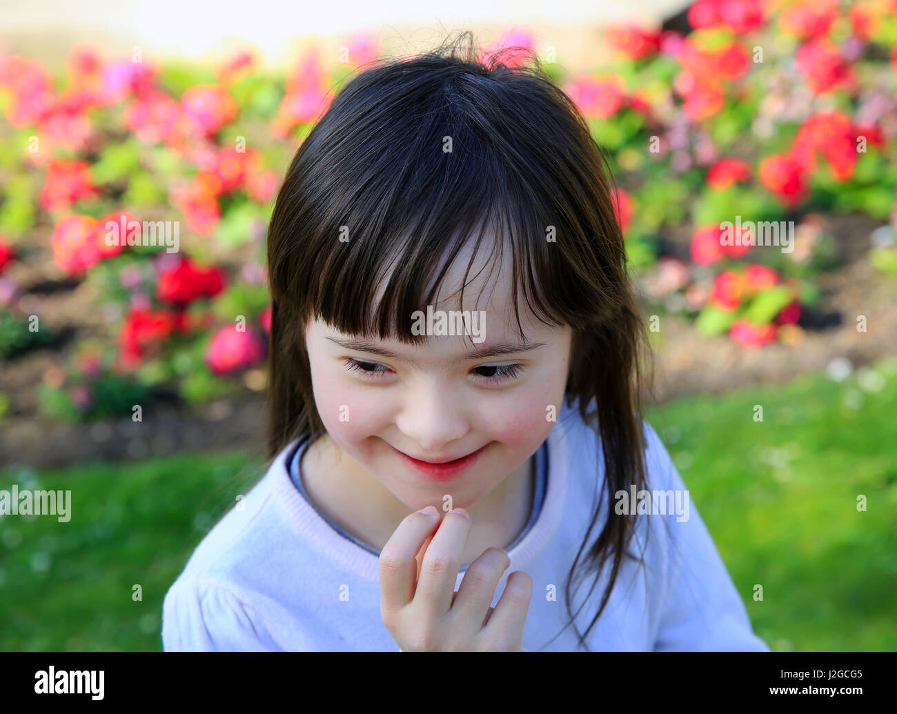 Portrait of little girl smiling outside Stock Photo - Alamy