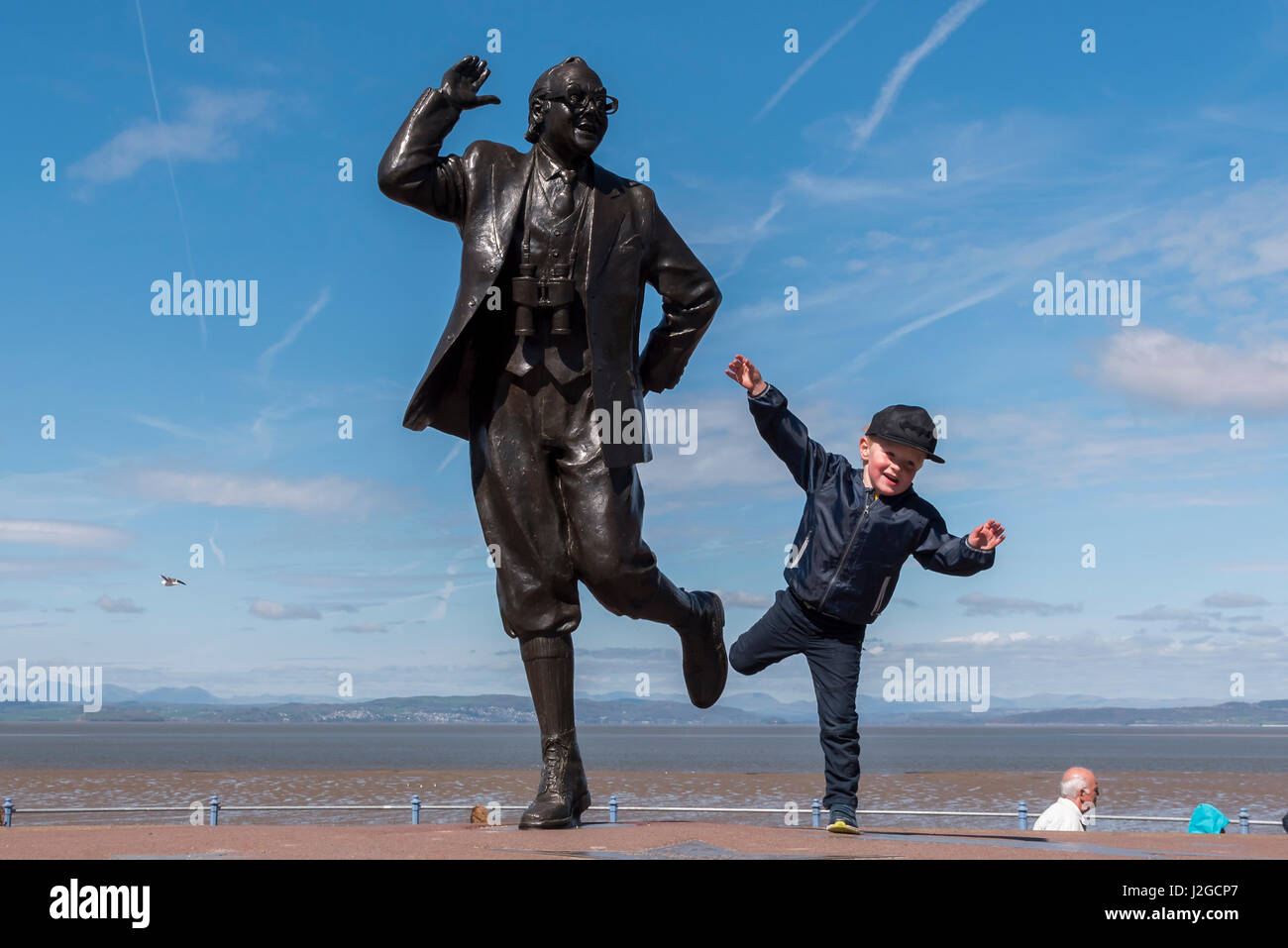 Eric Morecambe statue with young boy imitating the famous dance. Stock Photo