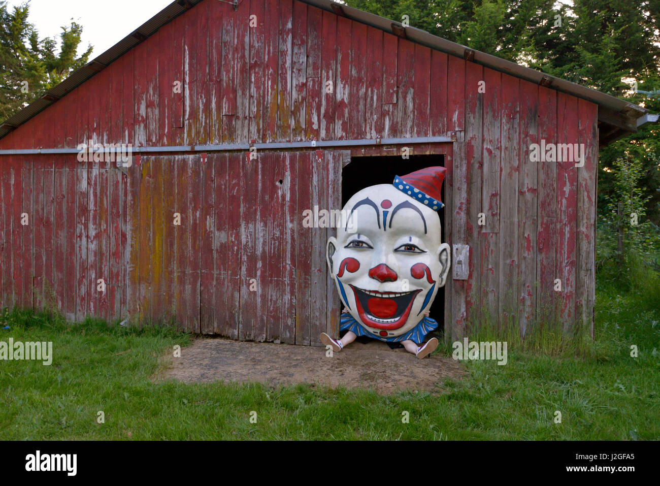 USA, Oregon, Oregon City. Person holding clown face in door of barn. Credit as: Steve Terrill / Jaynes Gallery / DanitaDelimont.com (Large format sizes available) Stock Photo