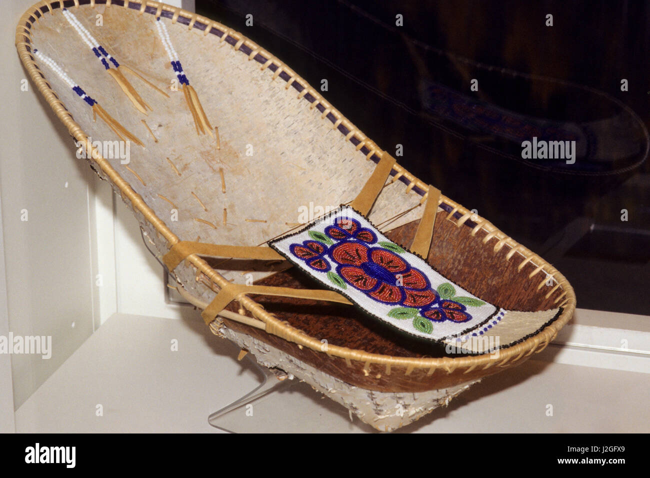 Traditional Athabaskan infant cradleboard made from birch bark and