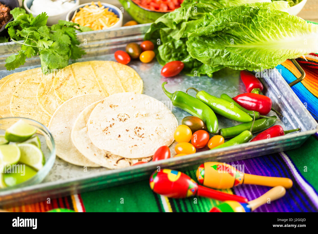 Ground beef tacos with romaine lettuce, diced tomatoes, radished, and