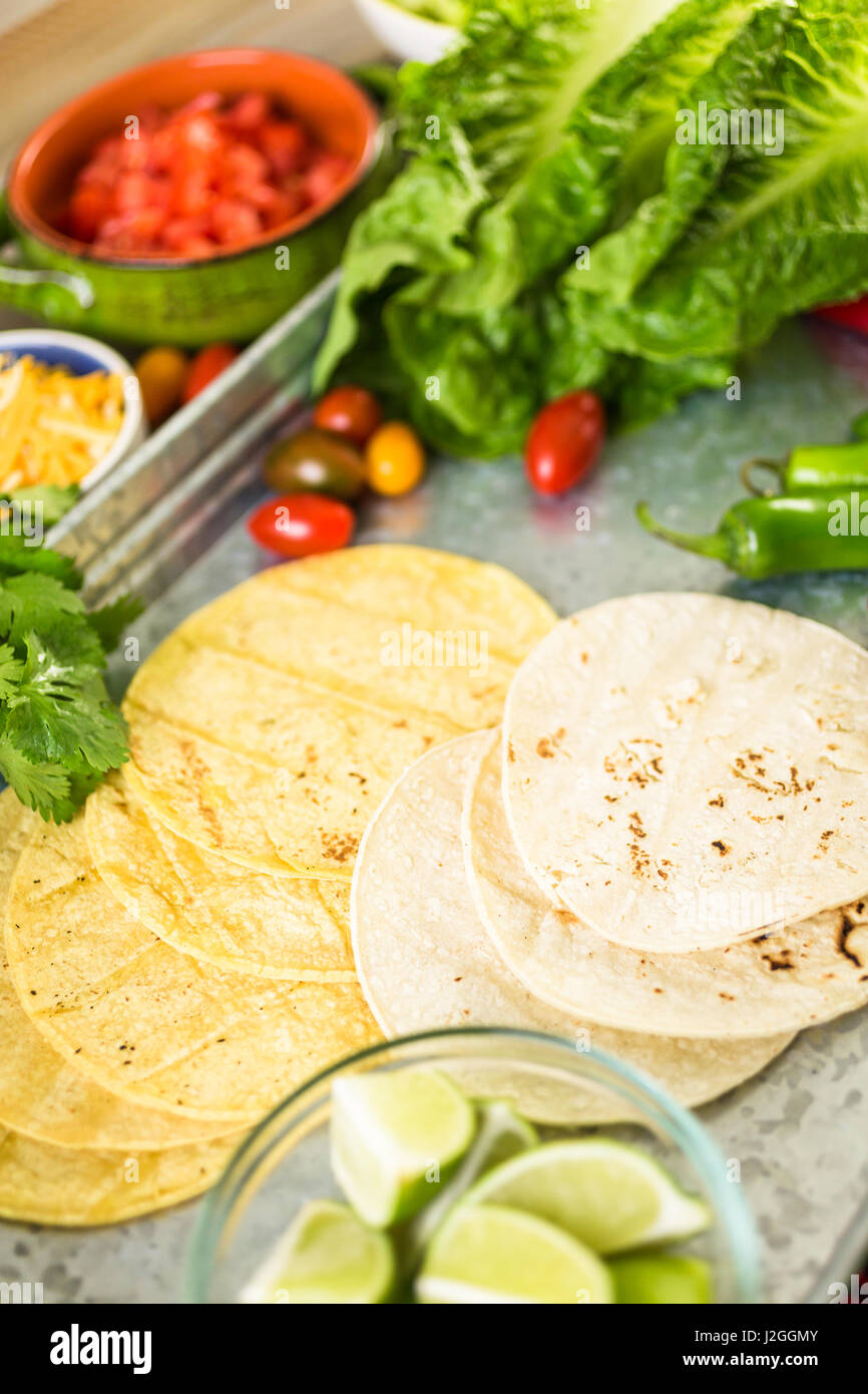 Ground beef tacos with romaine lettuce, diced tomatoes, radished, and