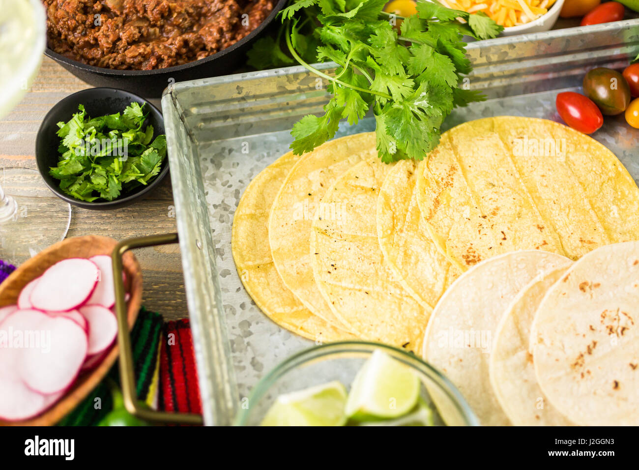 Ground beef tacos with romaine lettuce, diced tomatoes, radished, and
