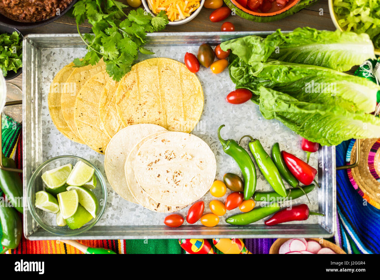 Ground beef tacos with romaine lettuce, diced tomatoes, radished, and