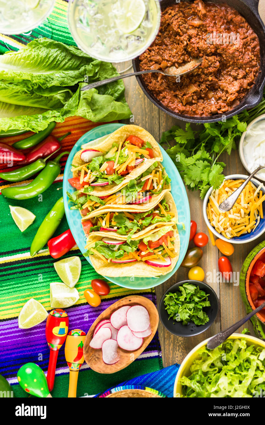 Ground beef tacos with romaine lettuce, diced tomatoes, radished, and