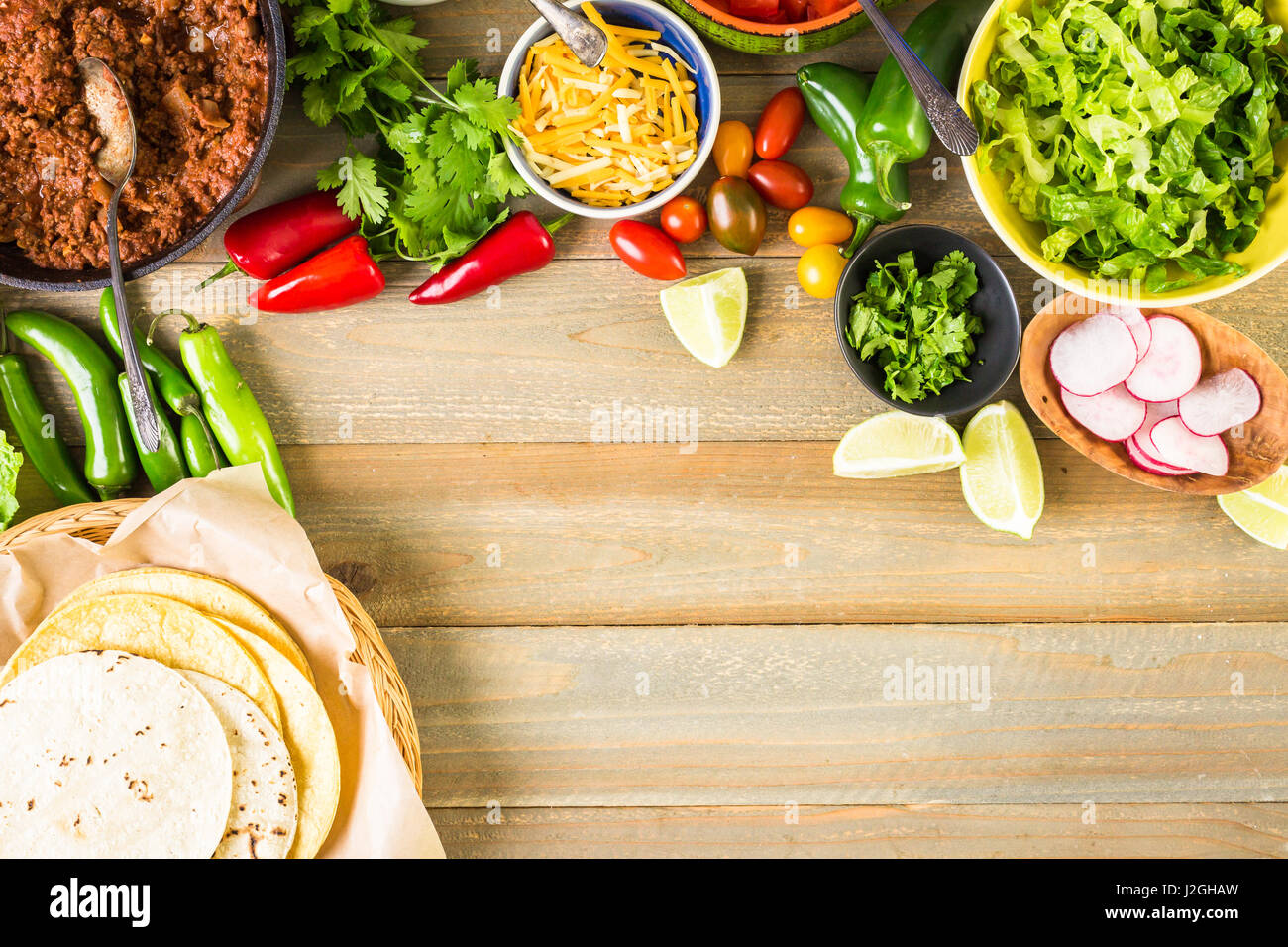 Ground beef tacos with romaine lettuce, diced tomatoes, radished, and