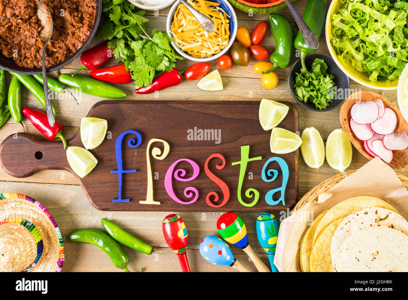 Ground beef tacos with romaine lettuce, diced tomatoes, radished, and