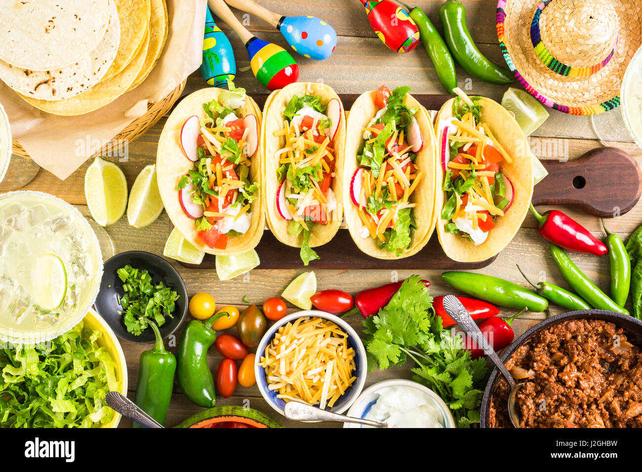 Ground beef tacos with romaine lettuce, diced tomatoes, radished, and