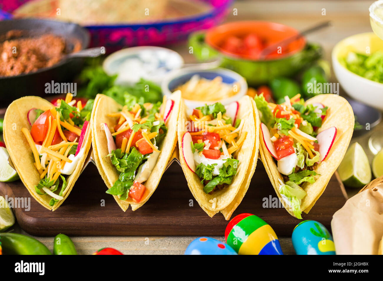 Ground beef tacos with romaine lettuce, diced tomatoes, radished, and