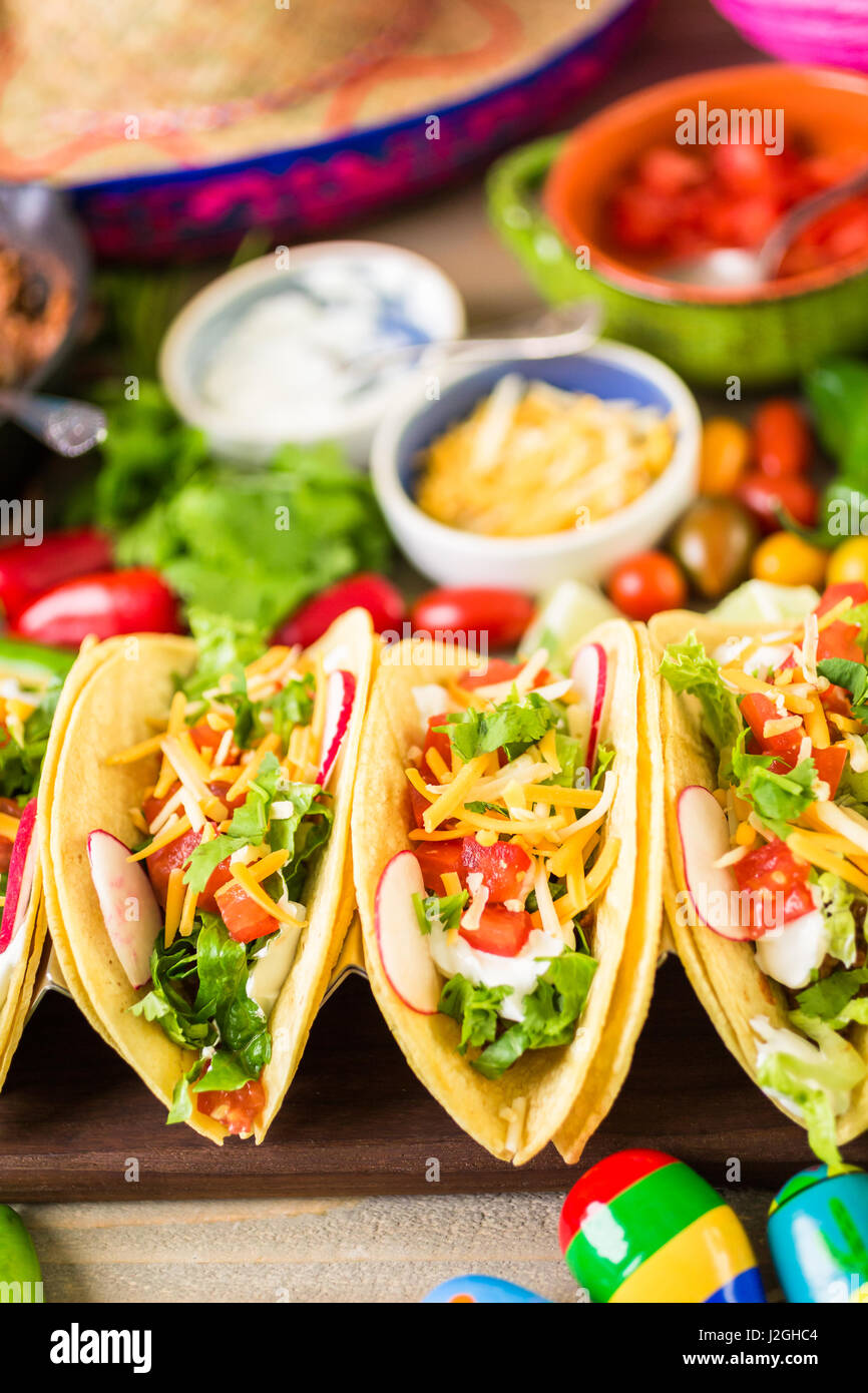Ground beef tacos with romaine lettuce, diced tomatoes, radished, and