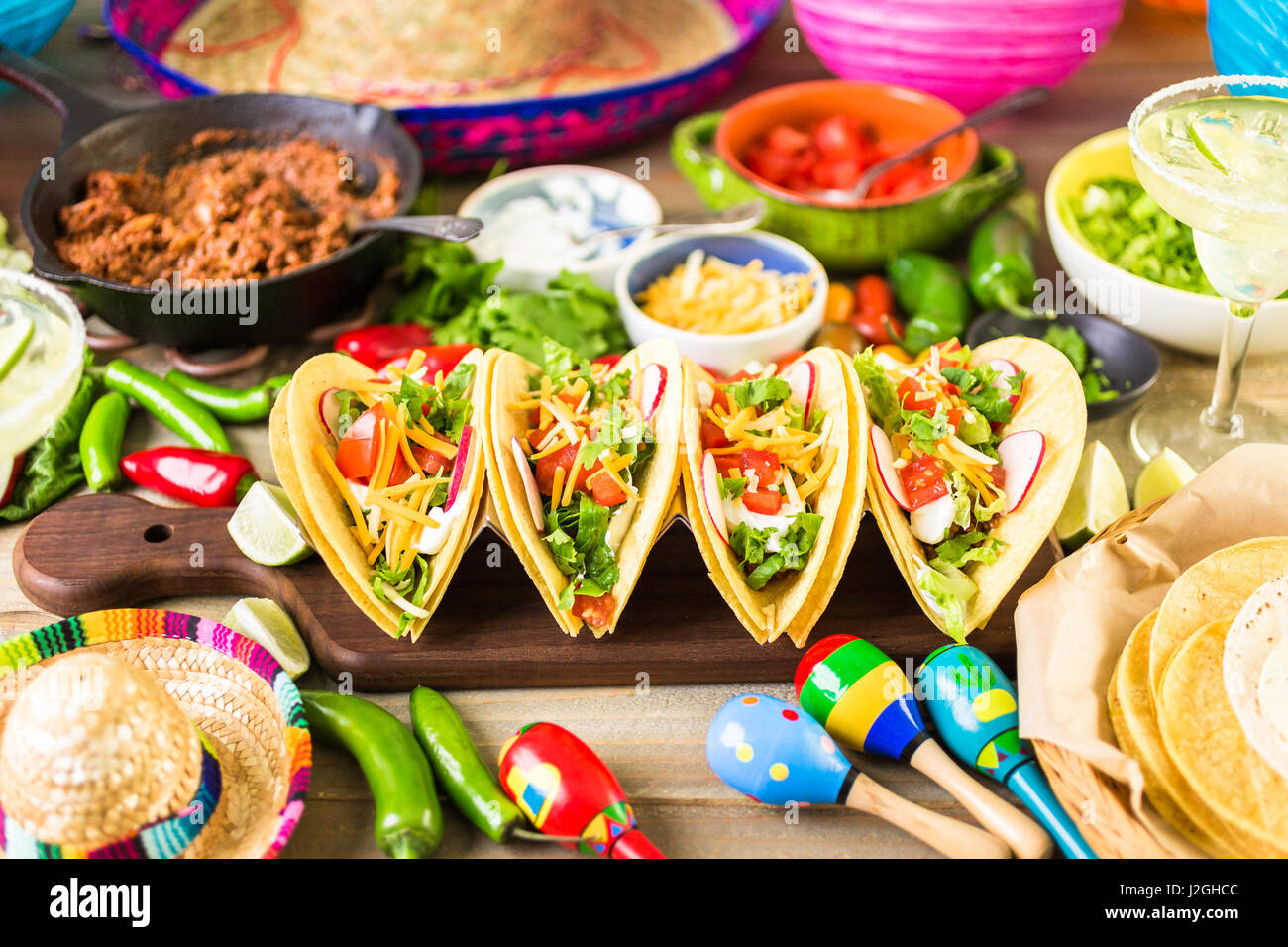 Ground beef tacos with romaine lettuce, diced tomatoes, radished, and