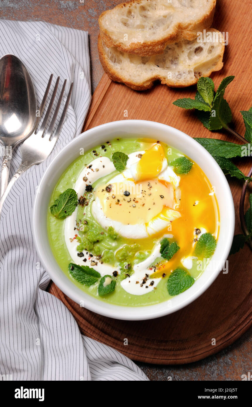 Pea puree soup with poached egg, sour cream, mint leaves seasoned with spices Stock Photo Alamy
