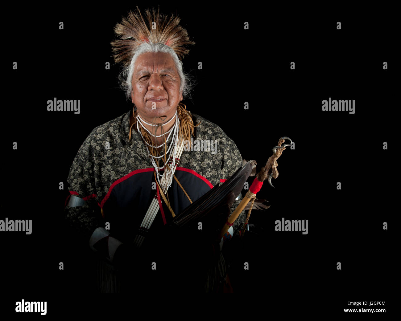 Traditional elder, Vernon Kennedy (Northern Paiute), holds an eagle wing fan and wooden stick with eagle talon (MR) Stock Photo