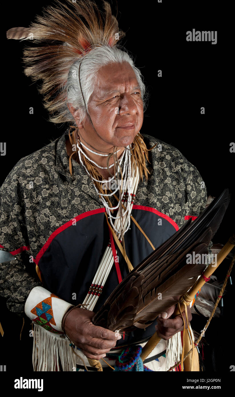Traditional elder, Vernon Kennedy (Northern Paiute), holds an eagle wing fan and wooden stick with eagle talon Stock Photo