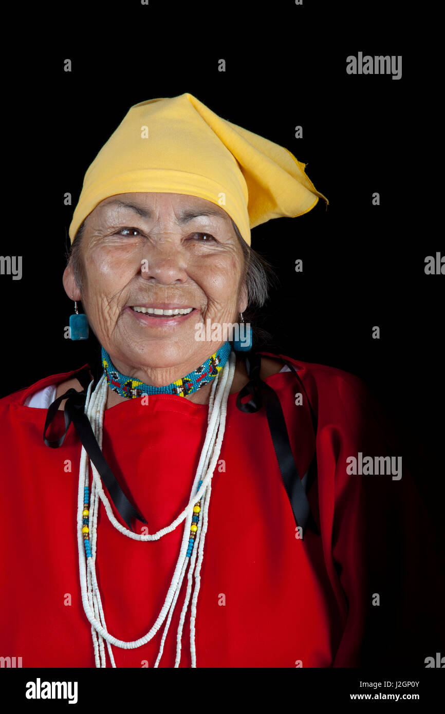 Elder Ardith Peyope (Shoshone-Bannock) dressed in traditional wing dress, beaded choker and scarf on black background Stock Photo