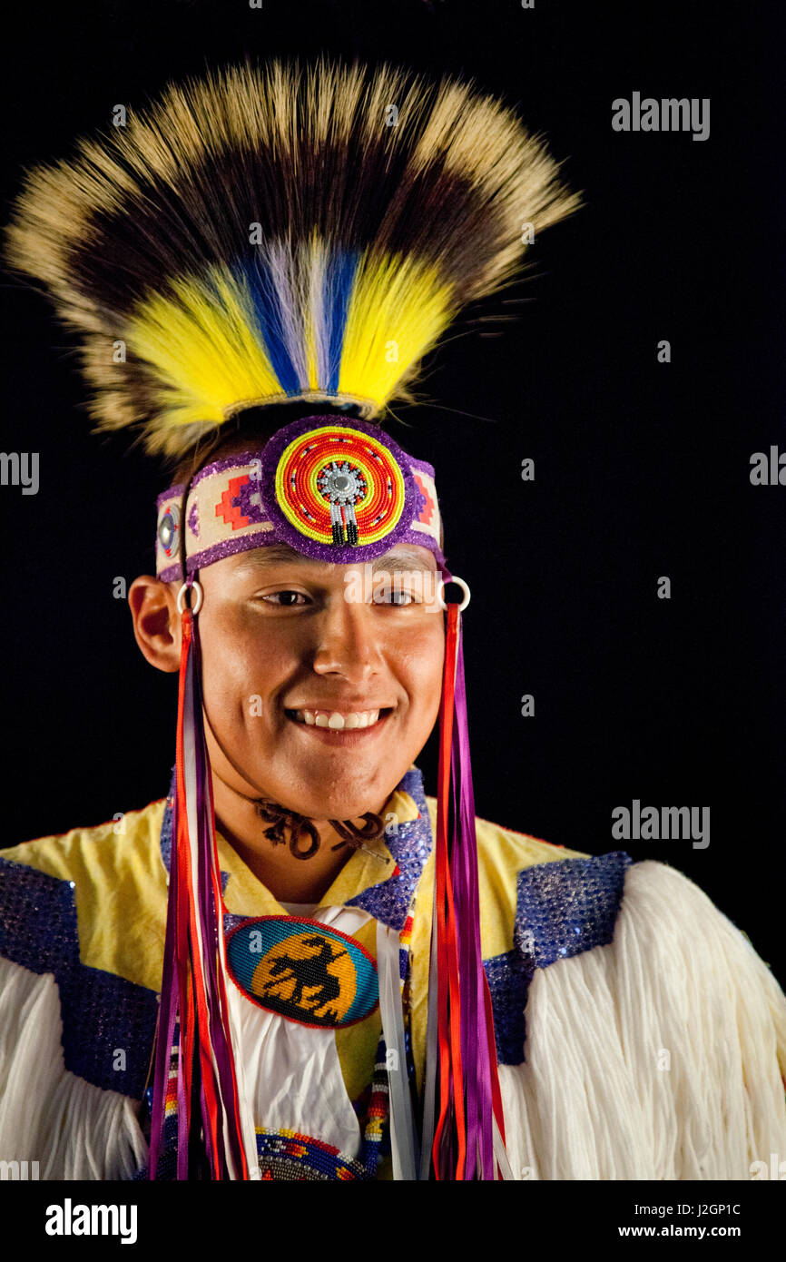 Neil Lahr, grass dancer (Blackfoot), dressed in pow wow dance regalia with black background. Stock Photo