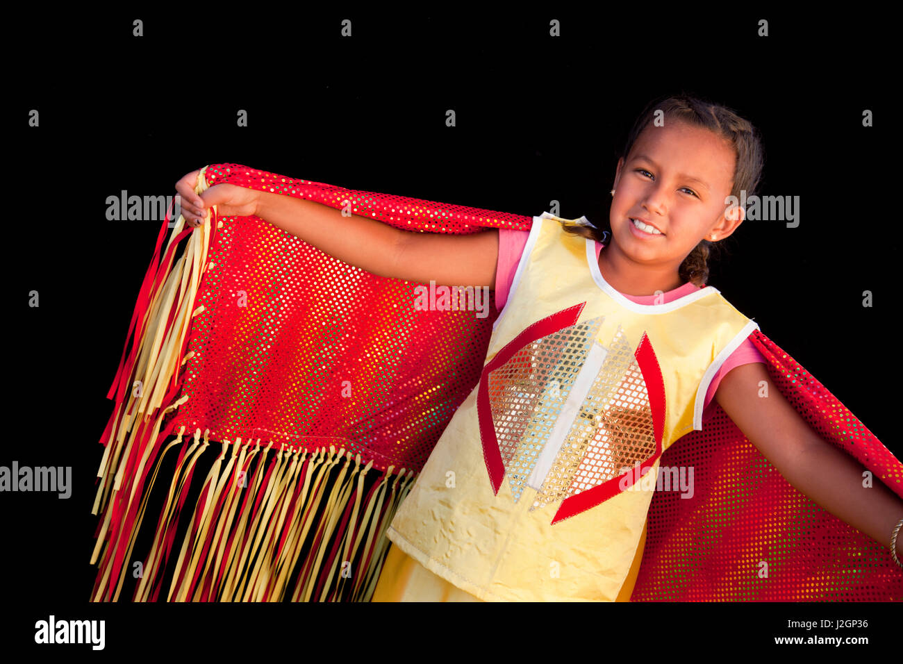 Girls shows off red and yellow outfit who is a fancy shawl dancer. Ruthee Rae Baker (Shoshone-Bannock Ponca) Stock Photo