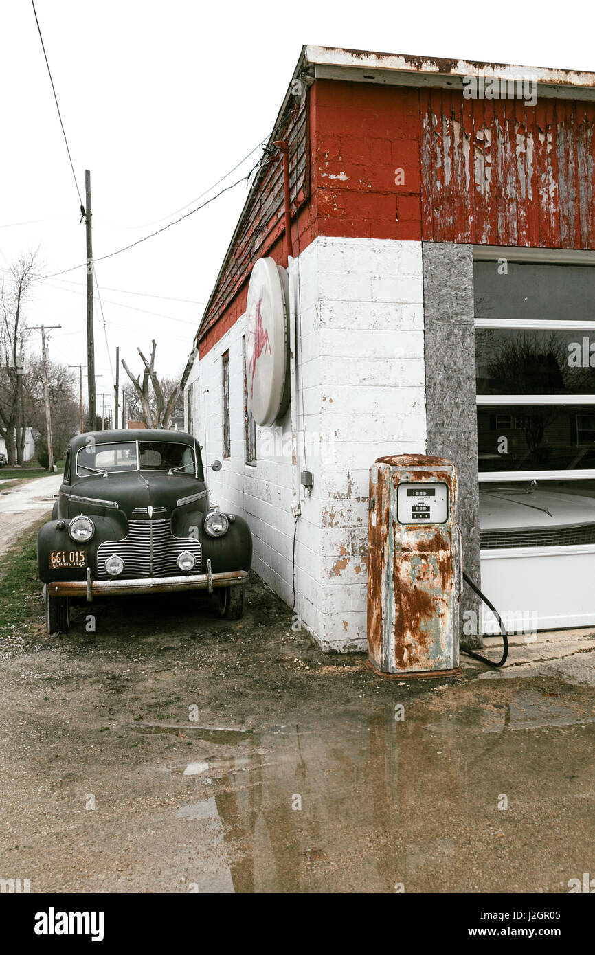 Antique car and gas pump outside a neglected garage, Dwight, Illinois