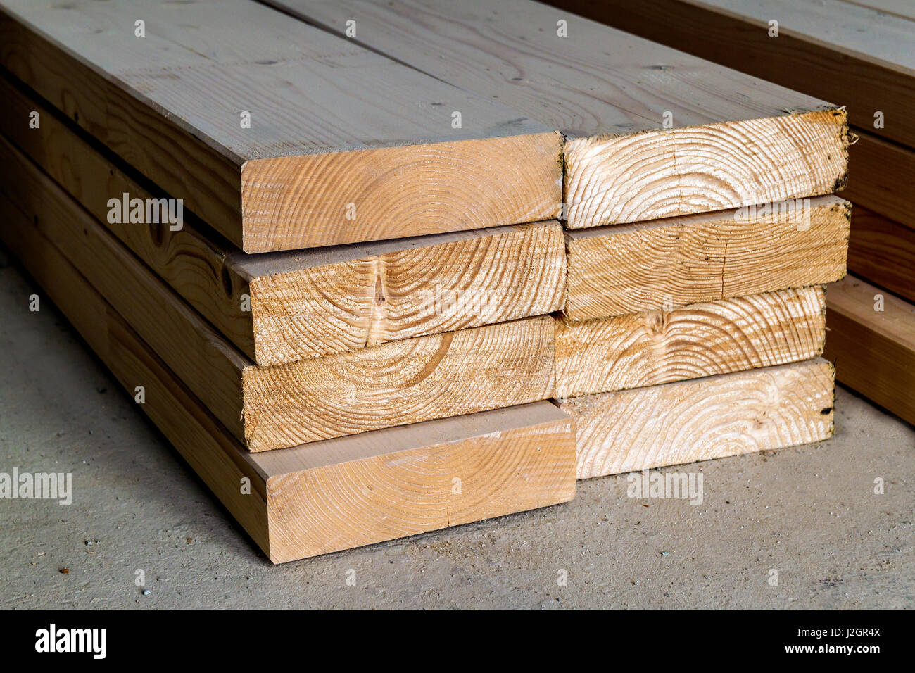 Stack of new wooden studs at the lumber yard. Wood timber construction