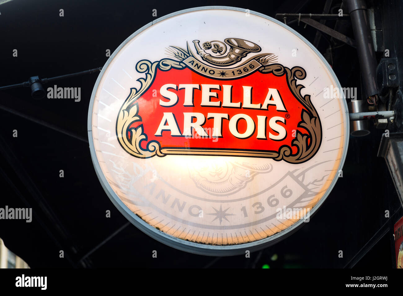 neonlit signpost with the logo of Belgian Stella Artois beer on black background Stock Photo