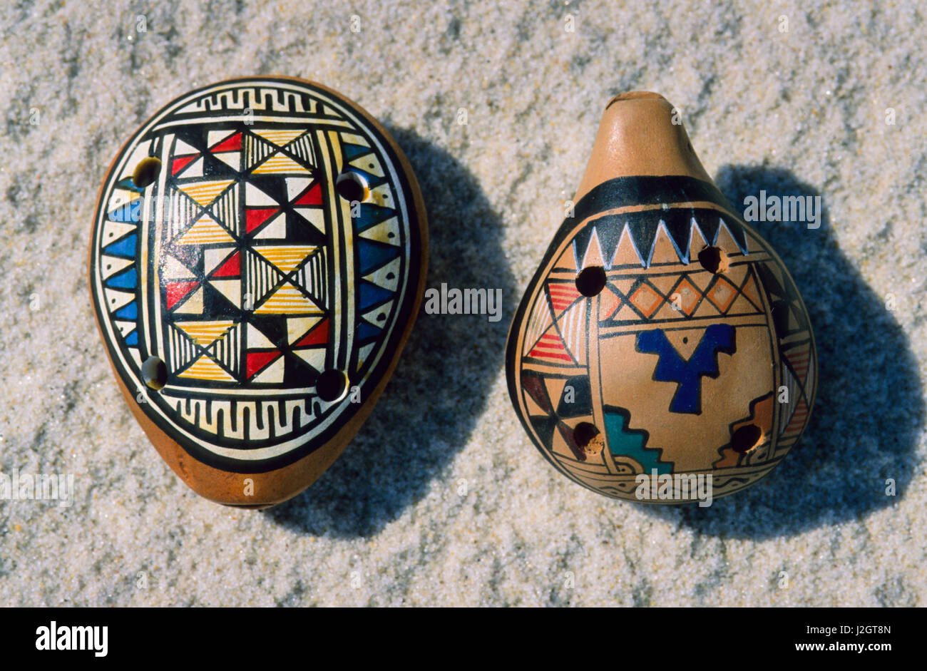 Arts and crafts of the Aztec are painted clay whistle flutes sold at markets in Mexico. Stock Photo