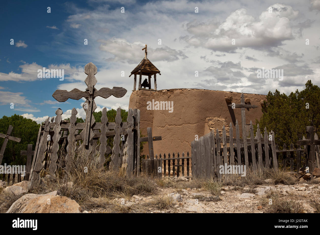 Adobe brick church and graveyard used by Spanish settlers in the early 1700's New Mexico by Spanish settlers. El Rancho de las Golondrinas (Ranch of the Swallows) is located in a rural farming valley near Santa Fe. Stock Photo