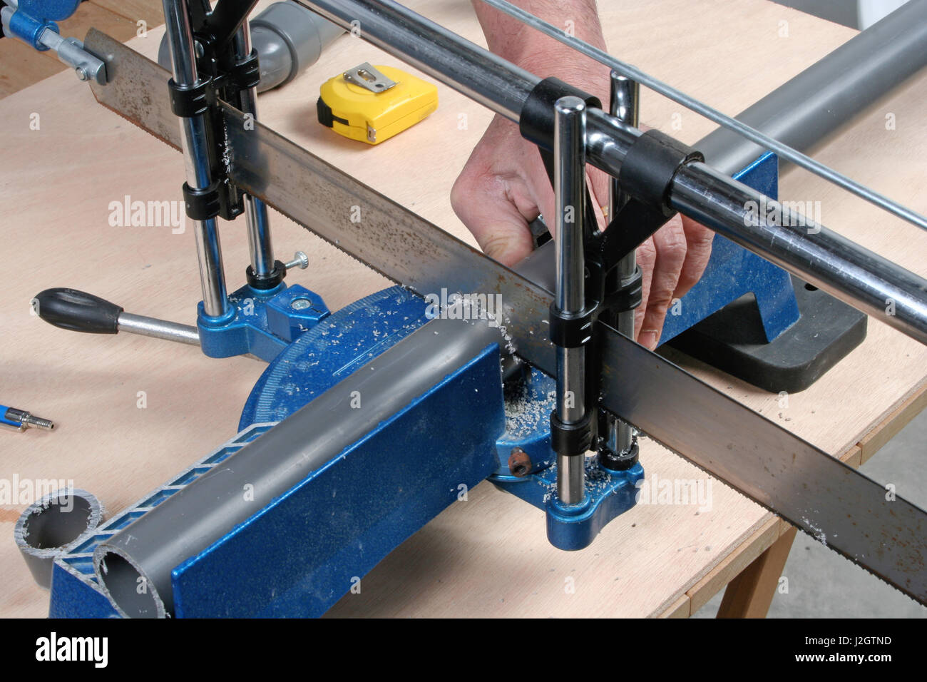Construction worker cutting pvc drain pipe with a saw Stock Photo Alamy