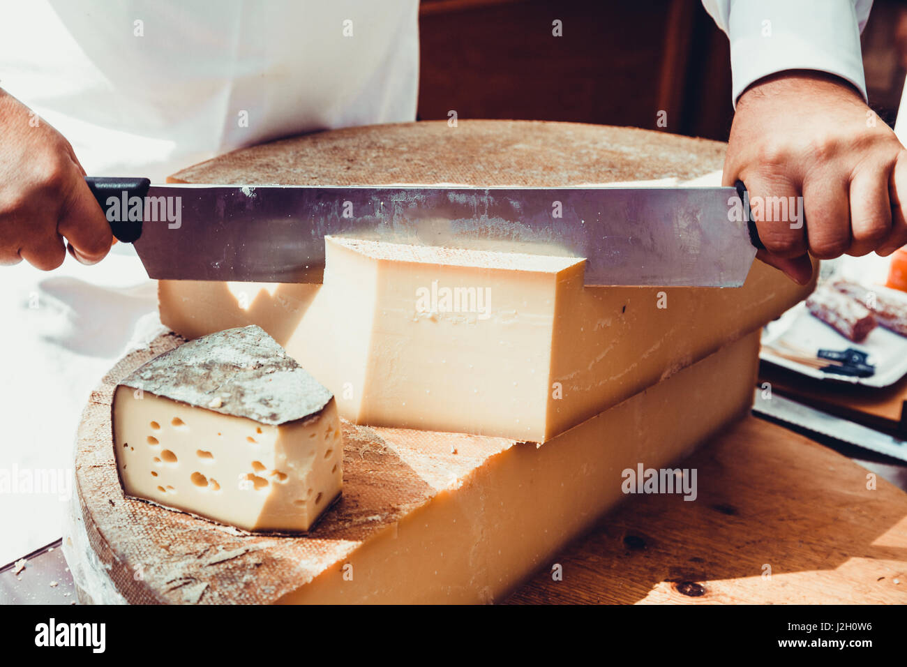 Worker slicing the cheese. Close up of Cutting cheese Stock Photo Alamy