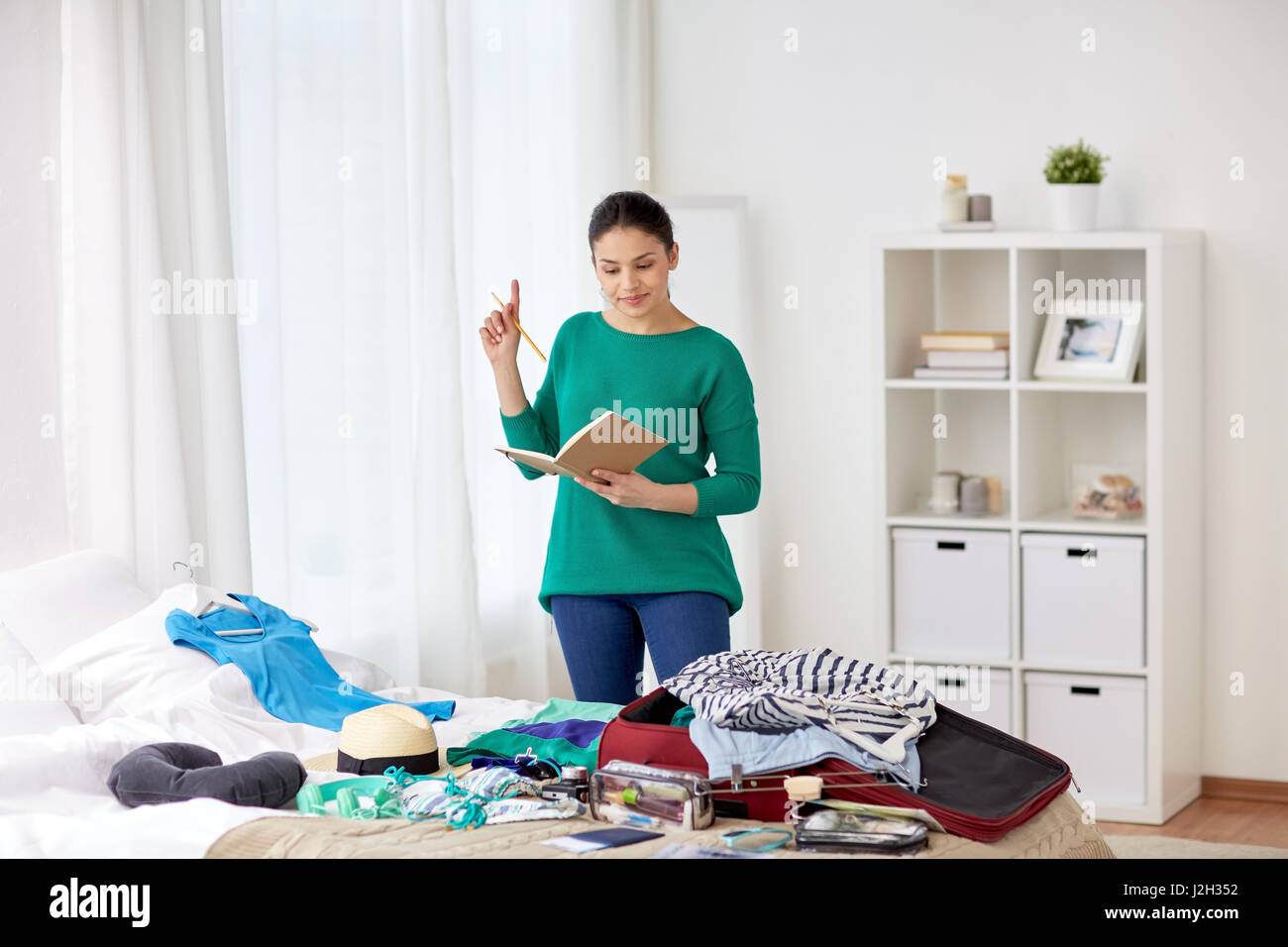 woman with notebook planning her trip at home Stock Photo - Alamy