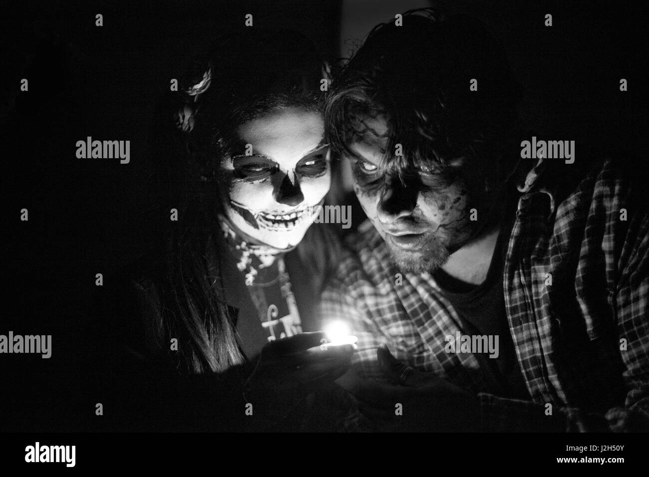 A girl andd man in the shape of a skeleton during a halloween Stock Photo