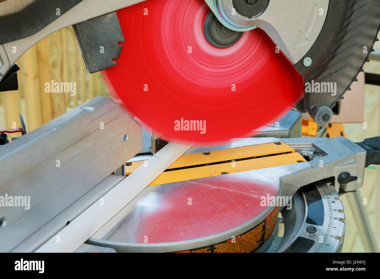 Man using saw to cut wood Man, worker sawing wood Stock Photo Alamy